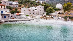 a group of buildings and a body of water at Arapis Rooms & Suites in Áyios Kiprianós