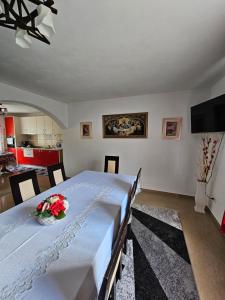 a bedroom with a table with a vase of flowers on it at Casa Alba in Borşa