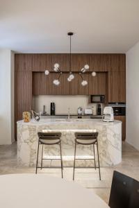 a kitchen with a large marble counter and two chairs at Luxe Rome apartment in Rome