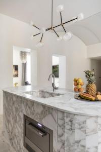 a kitchen with a marble counter top and a sink at Luxe Rome apartment in Rome