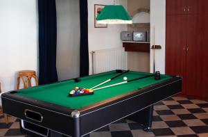 a pool table with balls in a room at Hotel Platán in Zamárdi