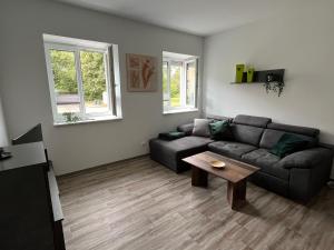 a living room with a couch and a coffee table at Ferienwohnung Kolow GbR in Angermünde