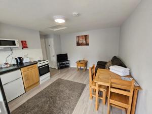 a living room with a kitchen and a dining room table at T & J Motel in Lamberhurst