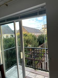 a view of a balcony from a room with a window at Narrow Street in London