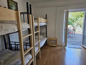 a room with bunk beds and a door to a patio at Guesthouse SOLE in Piran
