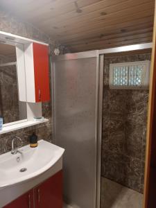 a bathroom with a shower and a sink at Saklı serender in Dernekpazarı