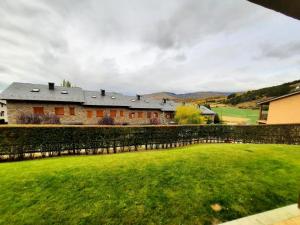 a house with a green yard and a building at Planta baja con jardín en Llívia in Llivia +27 photos