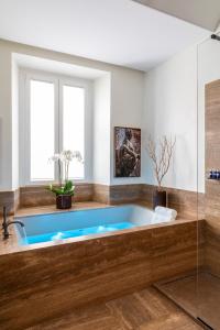 a bath tub in a bathroom with a window at Luxe Rome apartment in Rome