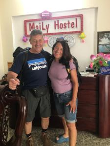 a man and a woman standing in a room at Maily Hostel in Hue