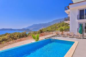 a villa with a swimming pool and a view of the water at Villa Sky Line in Kas