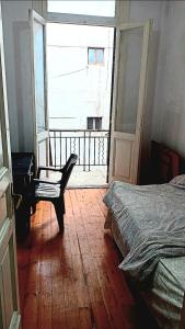 a bedroom with a bed and a desk and a window at ARAB Hostel For Men onlyغرف خاصة للرجال فقط 仅限男士 女士不允许 in Alexandria