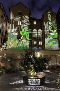 a building with a tree in front of it at Aquarium Exclusive Loft - Free Parking in Genoa