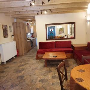 a living room with a red couch and a table at AROANIA suites in Zarouchla