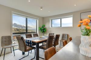 a dining room with a table and chairs at Queenstown Lake and Mountain View Retreat Free Wifi Free Street Parking in Queenstown