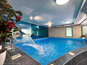 a swimming pool with a fountain in a building at Luxury Apartments Erol in Sarajevo