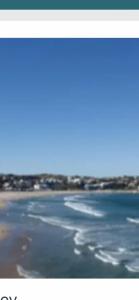 a picture of a beach with water and buildings at STUDIO IN BONDI in Sydney