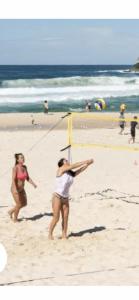 two women on the beach playing with a kite at STUDIO IN BONDI in Sydney