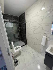 a bathroom with a toilet and a shower and a sink at Airport See Viem Apartment in Arnavutköy +19 photos