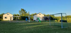 a yard with a playground with at Domek Jozef z prywatnym duzym Jacuzzi i sauna Przystan pod niebem in Łęzyce