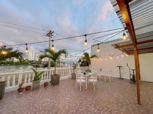 a patio with a table and chairs on a balcony at 2 bedroom apartment 2CB-3 in Getsemani in Cartagena de Indias