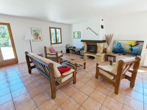 a living room filled with furniture and a fireplace at Le ti Pompon in Saint-Pompont