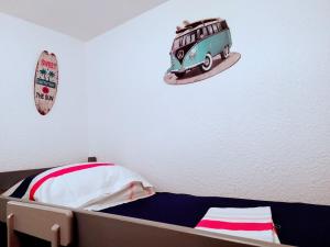 a bedroom with a bed with a bus on the wall at ALAMANDA STUDIO LE GRAU DU ROI - in Le Grau-du-Roi