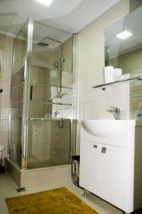 a bathroom with a glass shower and a sink at Casa Elena 