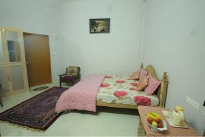 a bedroom with a bed and a table with a bowl of fruit at The Forest Resort - Muneeswaramudi Eco Hermitage and Farms in Tindummal