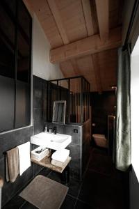 a bathroom with a sink and a mirror at La Loge de la Dolarde - Chambre Nord-Est in Prémanon