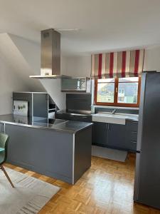 a kitchen with a sink and a counter top at Freundliche Wohnung Nähe Weinstraße für 5 Personen in Wagna