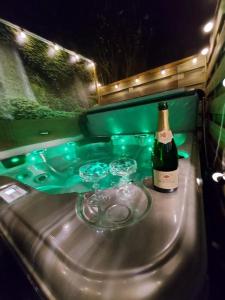 a bottle of wine and two glasses on a table at Aqua City Suite by Malmedreams in Malmedy