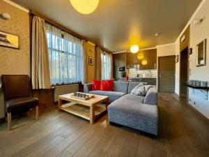 a living room with a couch and a table at Aqua City Suite by Malmedreams in Malmedy