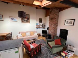 a living room with a couch and a fireplace at The Old Bakery in Alderney