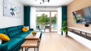 Televízia a/alebo spoločenská miestnosť v ubytovaní Apartamenty Good Time- Stone Hill II