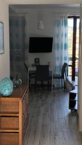 a living room with a television and a dining room table at argentario home in Porto Santo Stefano +16 photos