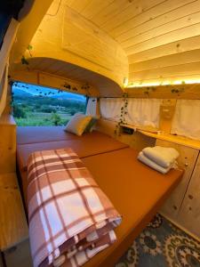 a small room with a bed and a window at Batroun van camping in Batroûn