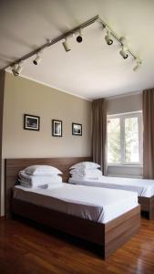 1 dormitorio con 2 camas y ventana en People Guest House, en Bishkek