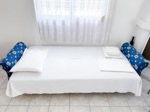 - un lit blanc dans une chambre avec fenêtre dans l'établissement myShell House, à Polychrono