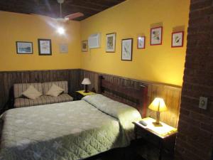 Cama ou camas em um quarto em Pousada Arboretum