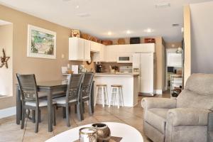 a kitchen and living room with a table and chairs at Barrier Dunes 426 - 62 Beach House Too by Pristine Properties Vacation Rentals in Oak Grove