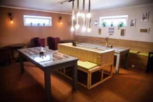 a room with two tables and a table and chairs at People Guest House in Bishkek