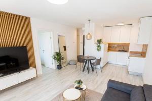 a living room with a couch and a table at Urban apartment with possibility of parking in Bratislava