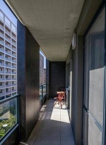 a hallway of a building with a table and chairs at Urban apartment with possibility of parking in Bratislava +3 photos