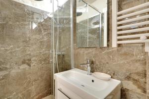 a bathroom with a sink and a shower at Pick A Flat's Apartment in Montmartre - Rue Drevet in Paris