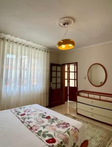 sypialnia z łóżkiem z komodą i lustrem w obiekcie Guest house tirana w Tiranie