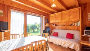 a bedroom with a bed and a large window at 35 CHALET - Chalet lumineux 6 pers in Morillon