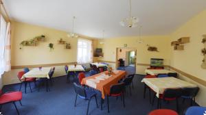 a restaurant with tables and chairs in a room at Penzion Poodří in Suchdol nad Odrou