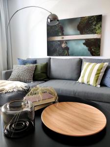 a living room with a couch and a wooden table at Trendy apartment in the heart of green Lahti, free parking in Lahti