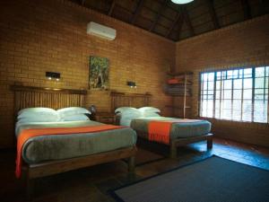 a room with three beds in a brick wall at Mokuru Private Nature Reserve in Brits +57 photos