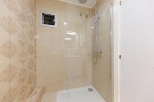 a bathroom with a shower with a glass door at Bravissimo Figuerola, Spacious 3-bedroom apartment in Girona +33 photos
